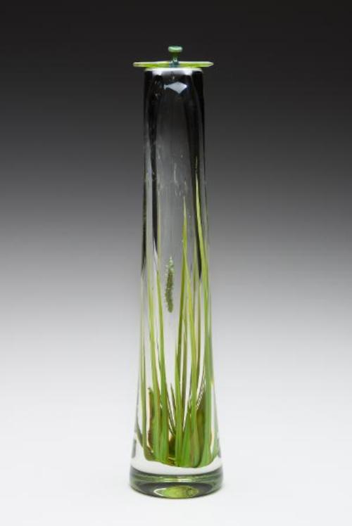 'In the Grass' The caterpillar is swinging from a fiber optic thread in the middle of this vessel